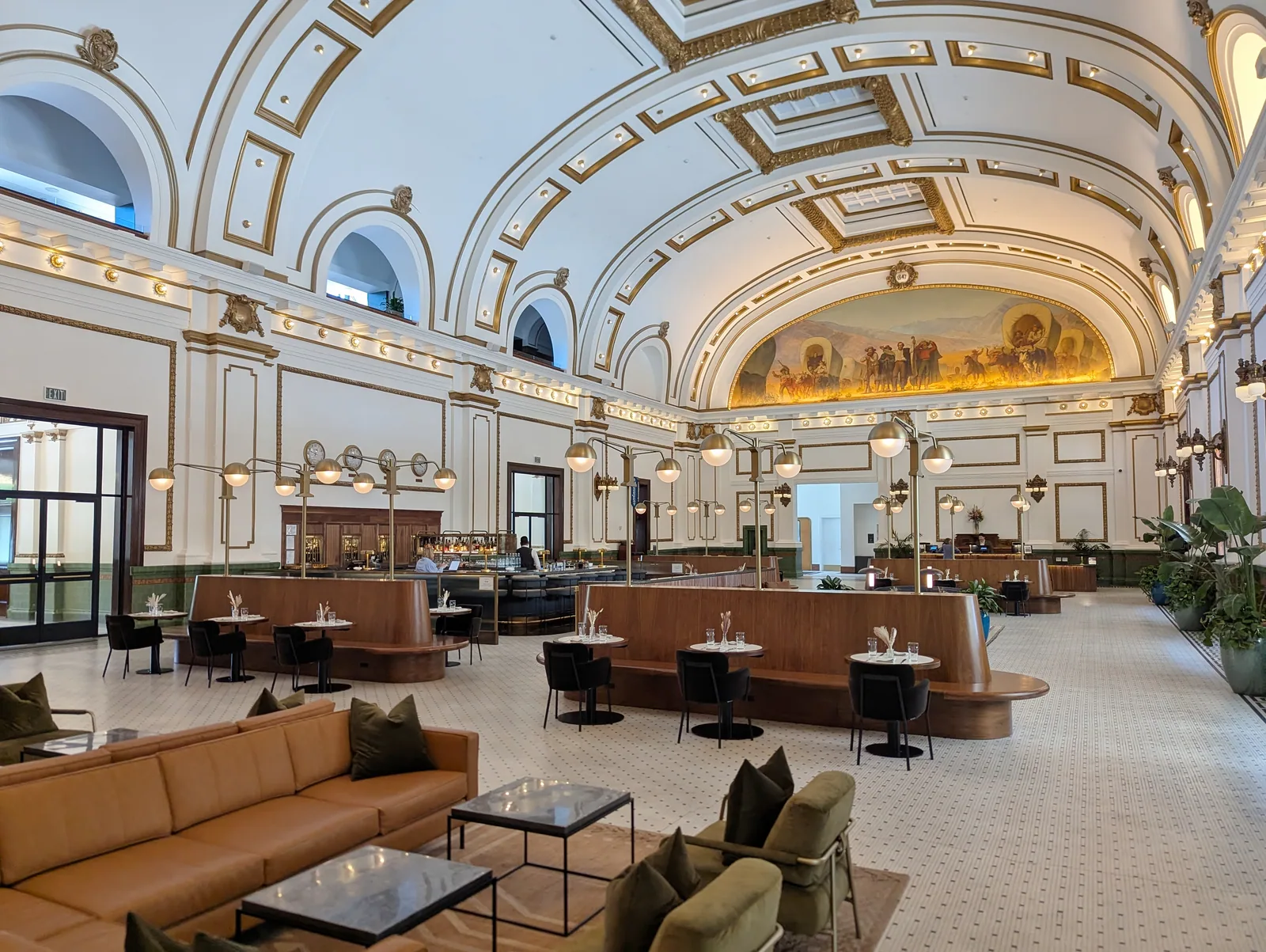 The Grand Hall of the Union Pacific Depot, a barrel-vaulted room with murals and stained glass at each end.