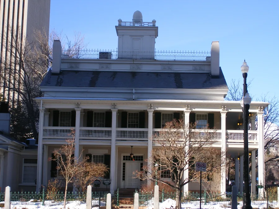 Brigham Young's Beehive House on South Temple Street, a white adobe and timber house with a two-storey veranda.