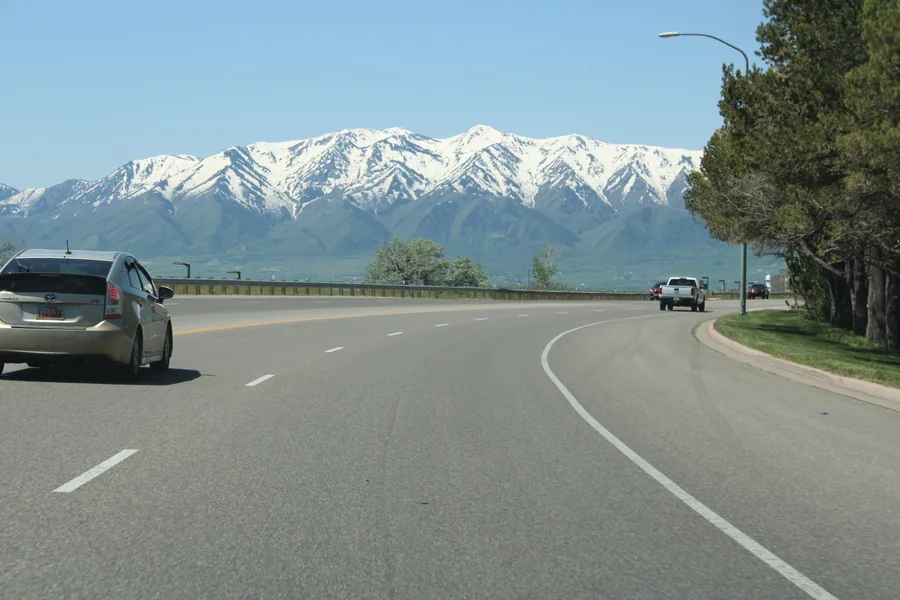 The highway north into Cache Valley with the snow-covered Wellsville Mountains ahead.