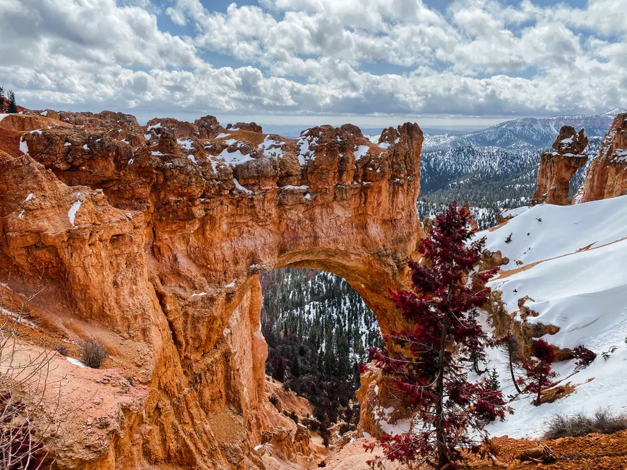A natural window in a snow-dusted rock formation at Bryce.