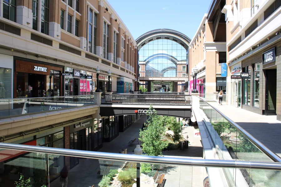 The glass-roofed arcade of City Creek Center, with the restored creek running below the walkways.