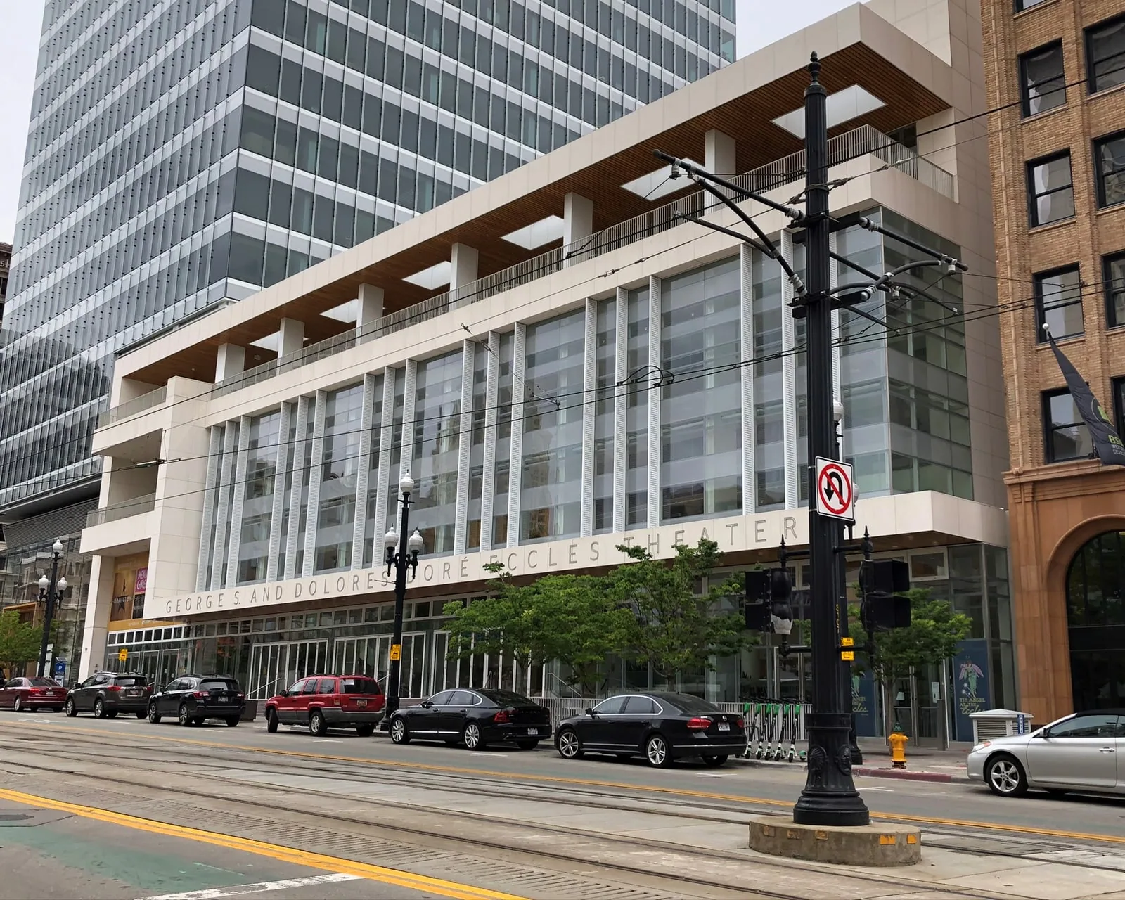 Historic Main Street looking north, the Eccles Theater glass front standing against the older brick commercial blocks beside it.