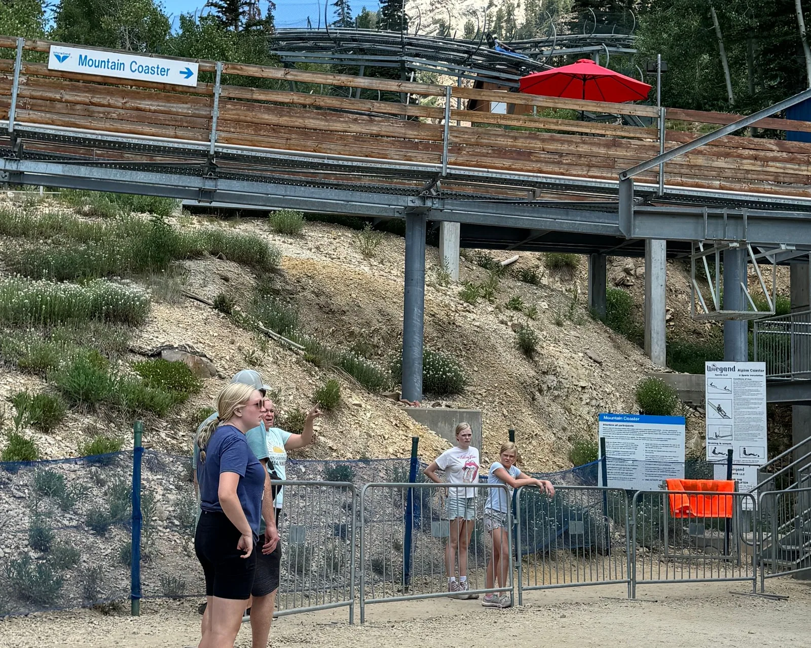 The Mountain Coaster at Snowbird, its track running above the base area, with a guide showing guests where the ride starts.