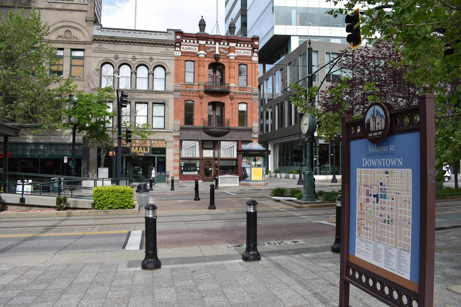 The 1887 Karrick Building on Historic Main Street, its red brick and iron balconies standing between an older stone block and a modern glass front.