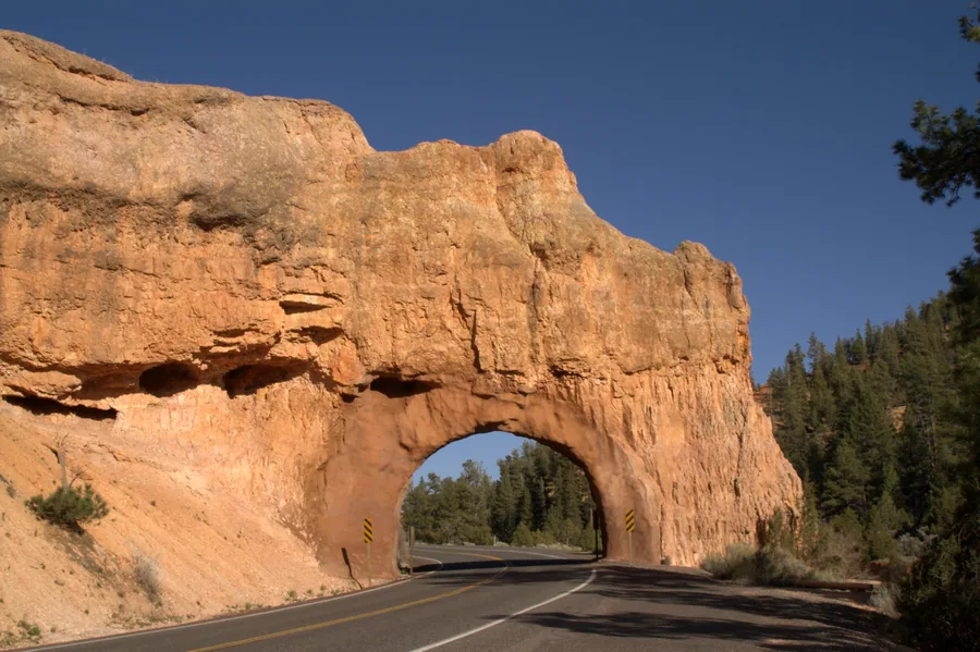 The road tunnel cut through red rock on Scenic Byway 12 at Red Canyon, on the way in.